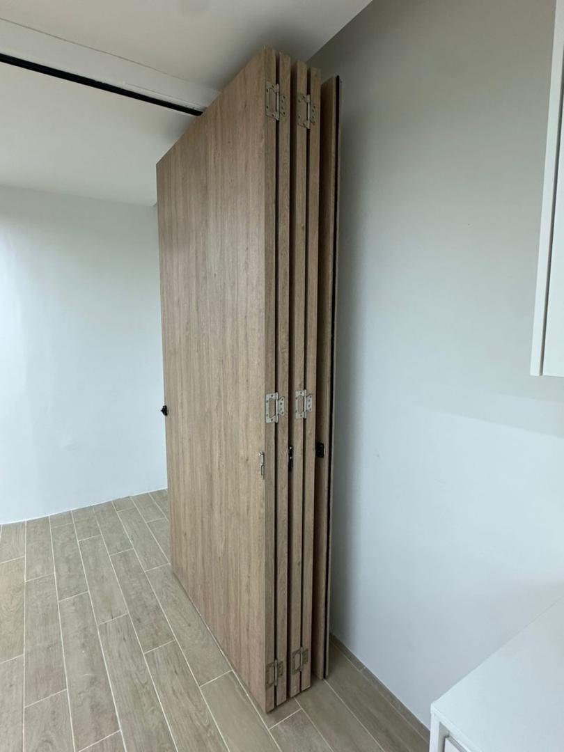 Space-saving custom folding timber door for commercial office renovation