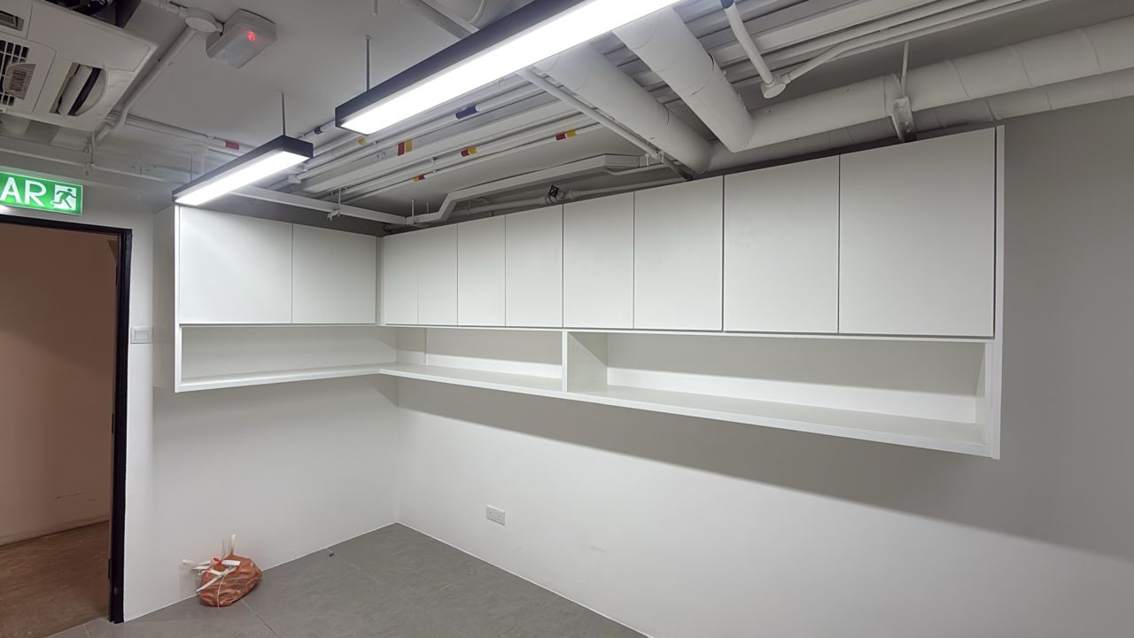Custom wall-mounted overhead cabinets for commercial office workspace