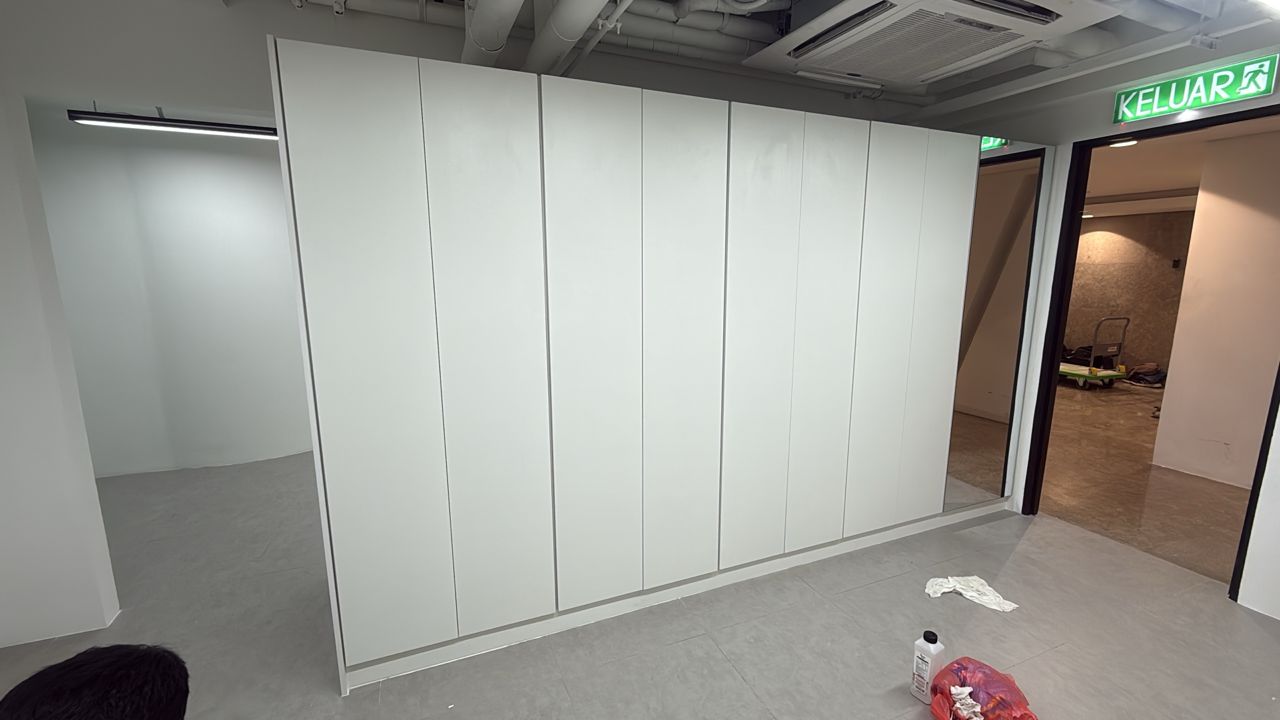 Custom full-height office storage wall with concealed cabinet doors
