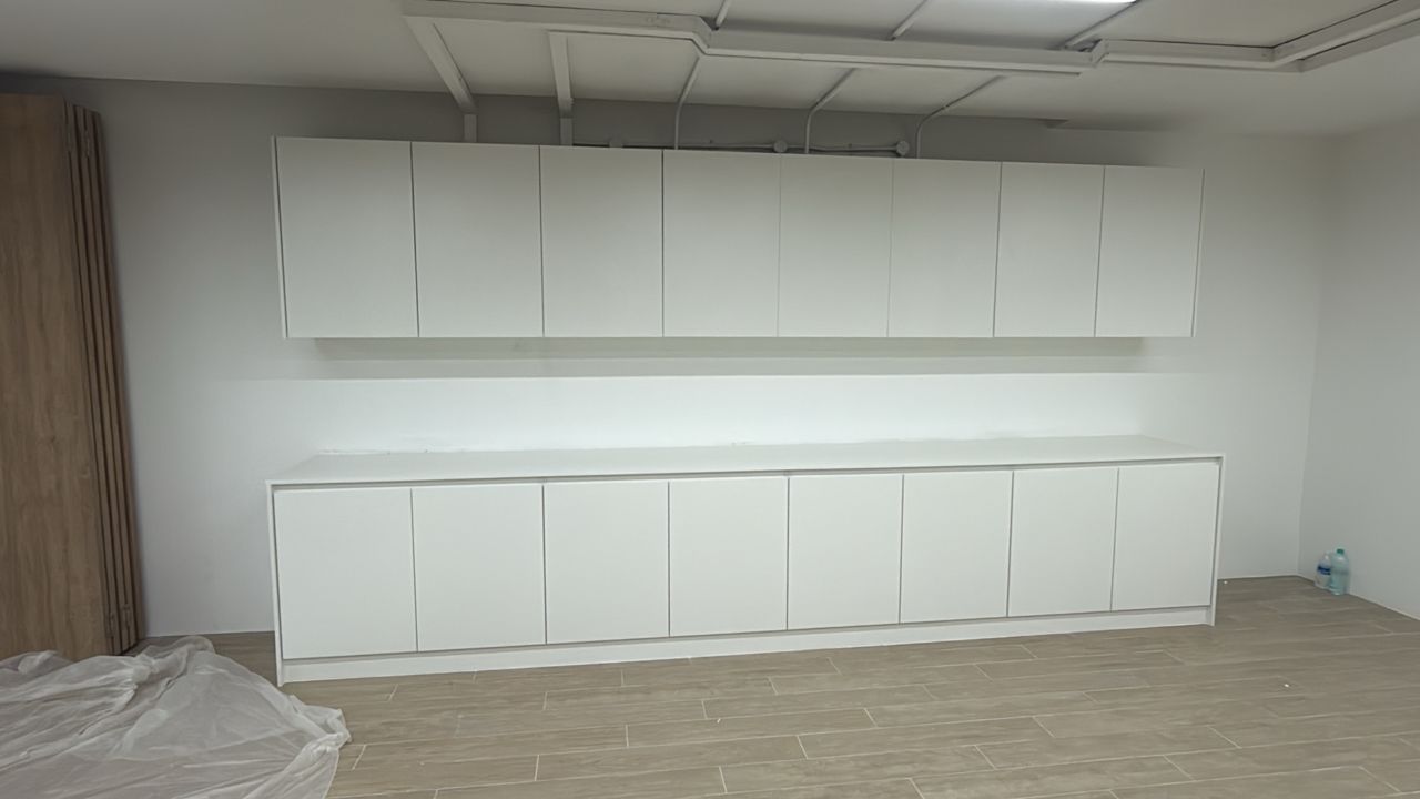 Commercial office renovation with custom base and wall-mounted storage cabinets