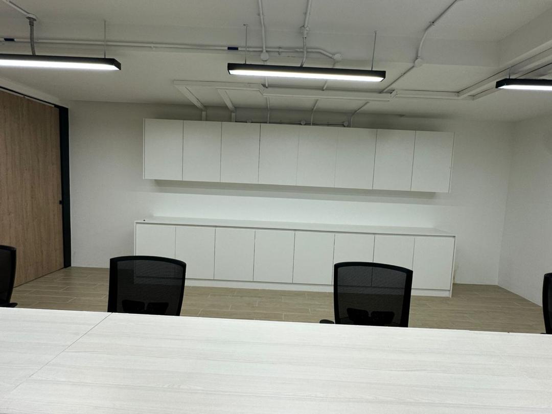 Commercial office meeting room with custom cabinetry and linear lighting