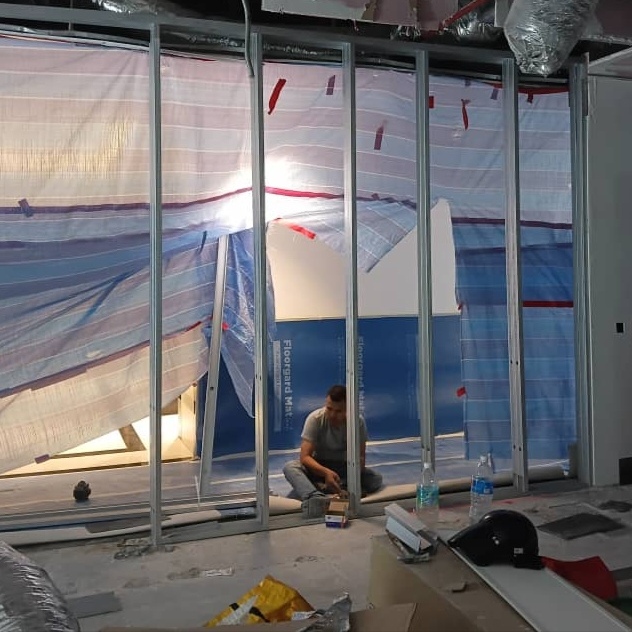 Metal stud frame installation for fire-rated gypsum board partition at Menara Pavilion