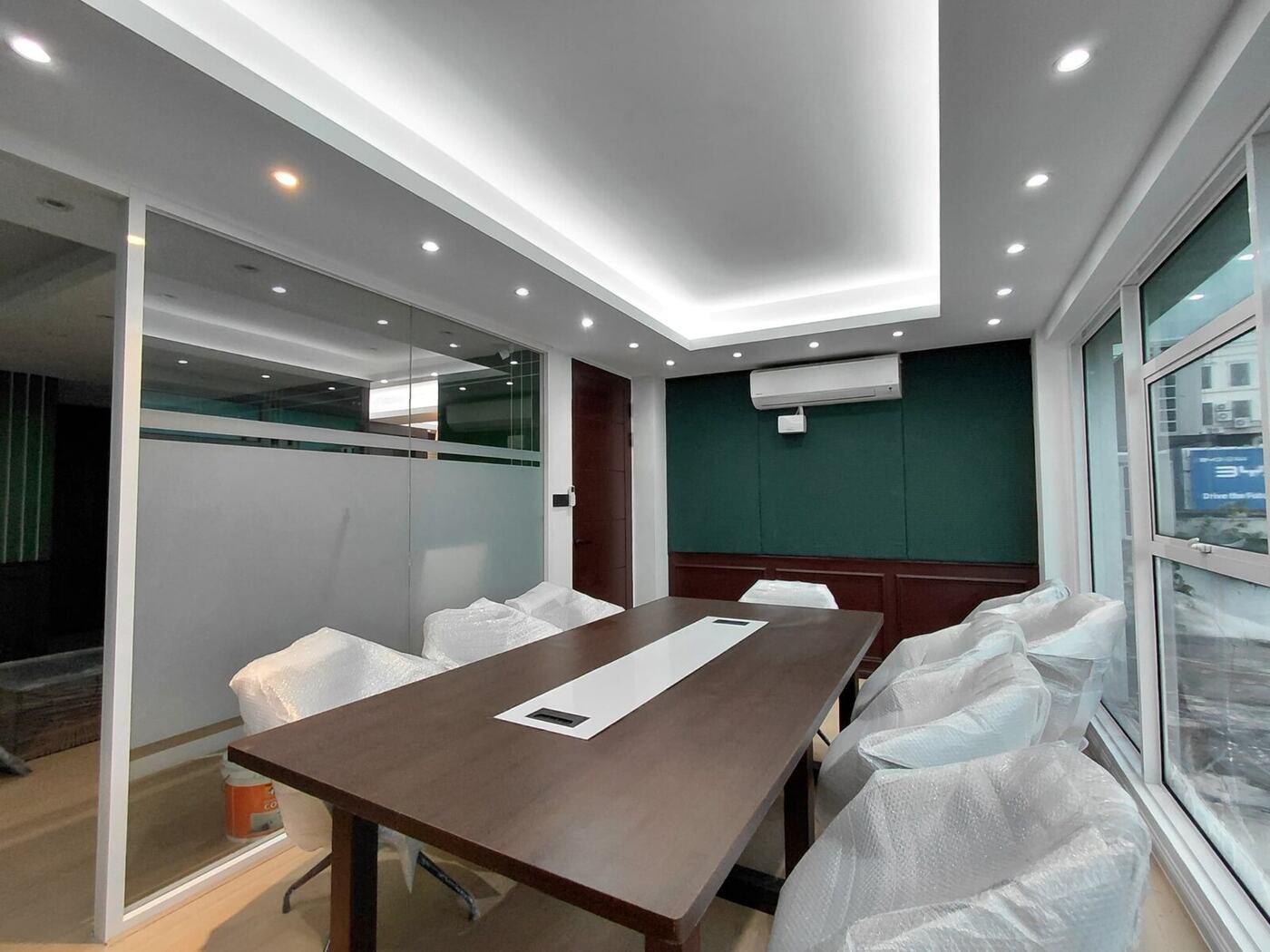 Ralph Lauren concept office boardroom with glass partition, recessed lighting and custom meeting table