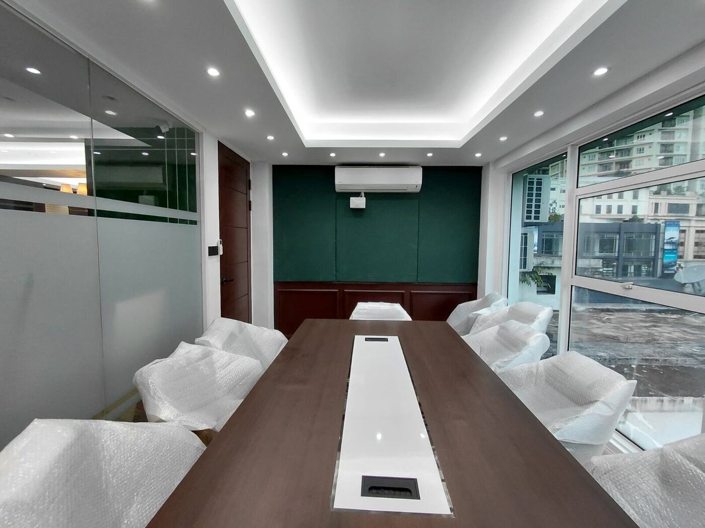 Completed Ralph Lauren concept meeting room with custom table, glass partition and green feature wall