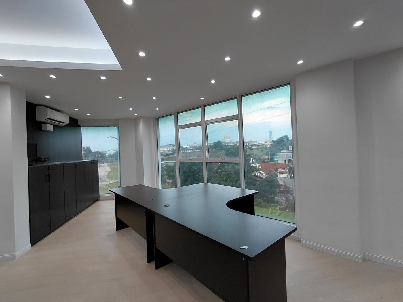 Corporate office executive workstation with natural light, custom desk and built-in storage