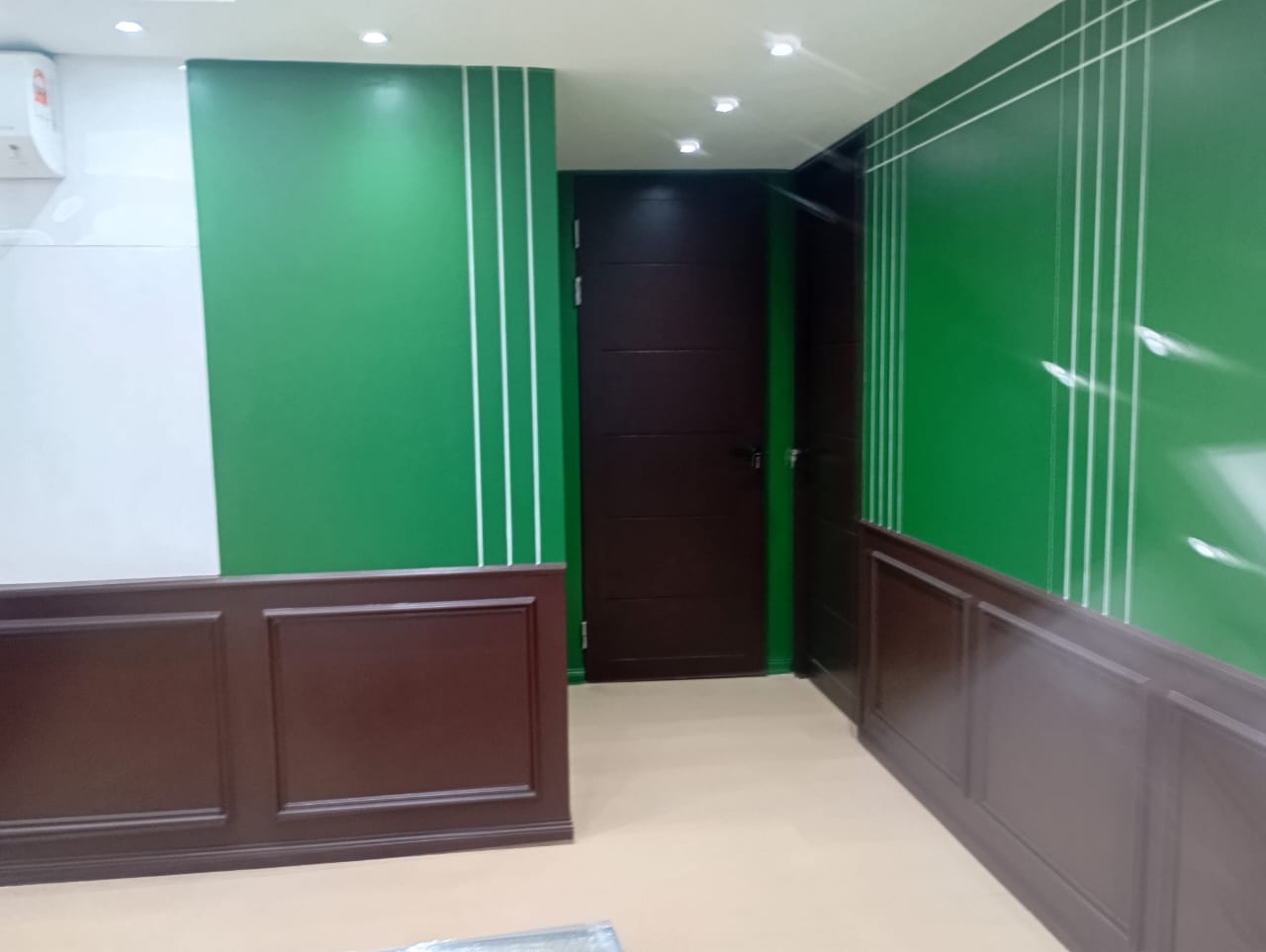 Ralph Lauren concept corporate office renovation with green wall panels and executive work area