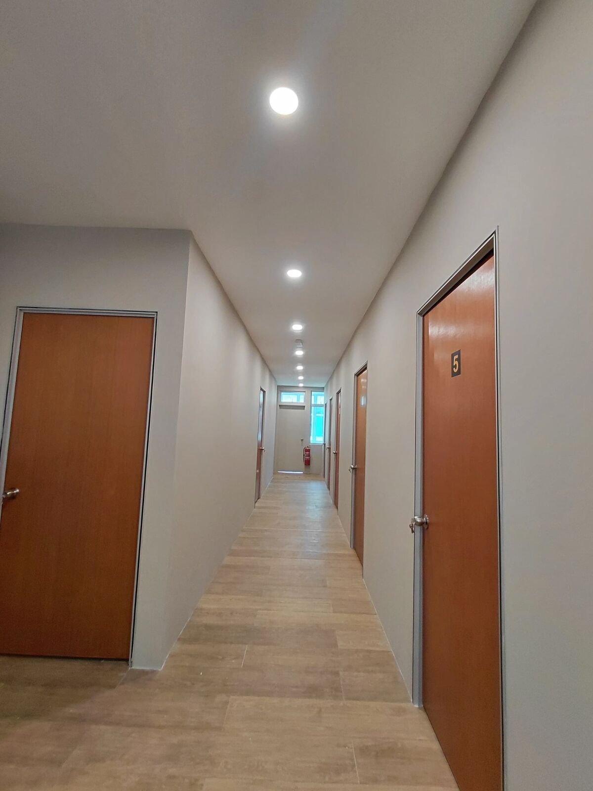 SPA Bangi completed interior corridor with doors and recessed lighting