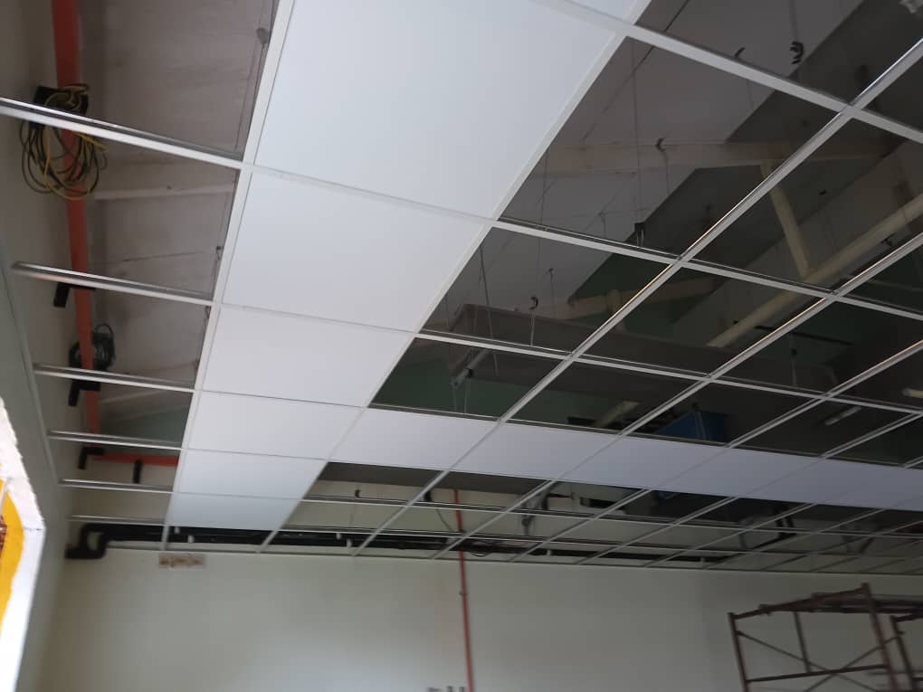 Modular suspended grid with installed central band of white ceiling panels